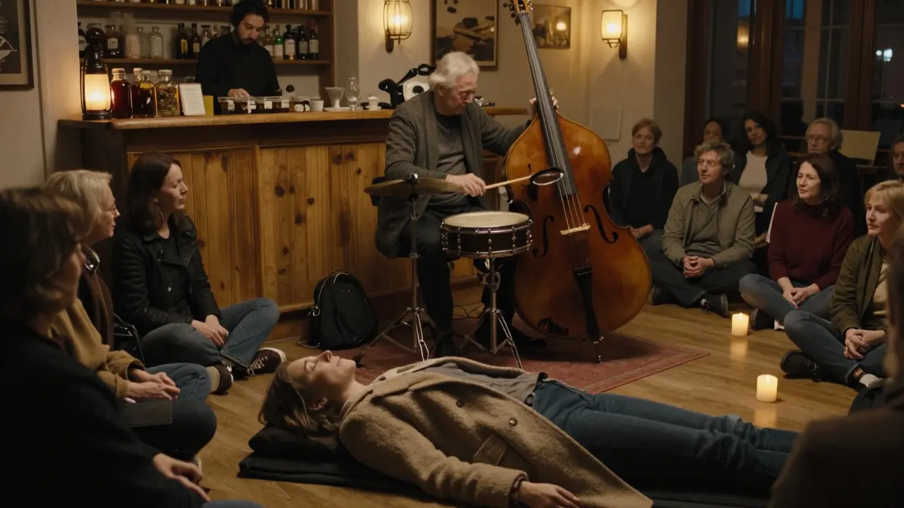 Diverse group of people listening quietly to live music inside a wooden barge, projections dancing on the ceiling.